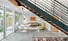 Modern home with Living Room, Chair, Sofa, Table, Concrete Floor, Lamps, Coffee Tables, Wall Lighting, and End Tables. Living/Client Lounge and Meeting Area Photo of Live/Work Space