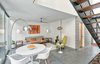 Modern home with Living Room, Coffee Tables, Wall Lighting, Concrete Floor, Sofa, Lamps, End Tables, Chair, and Table. Entrance Vestibule, Living/Client Lounge and Meeting Area Photo 2 of Live/Work Space