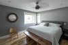 The master bedroom has a corner window. Photo 20 of Burlington Residence modern home