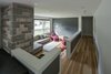 The existing sunken living room was refurbished and has state of the art electronics seamlessly stitched into custom millwork. Photo 18 of Burlington Residence modern home