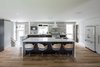 The kitchen which is central to family life, commands the area opposite the entry. Photo 15 of Burlington Residence modern home