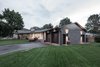 The angle of the original house had no bearing to either street on the corner, the addition (perpendicular/parallel to the streets on the corner) introduces a contextual geometry to the scheme. Photo 6 of Burlington Residence modern home