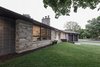 The existing stone was a central material in the project's material palette. It disciplined all subsequent material selections. Photo 3 of Burlington Residence modern home