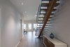 The idea was that from the moment you entered the house, you were aware of the water, consequently, the stair was designed with open risers. Photo 10 of Turkey Point Beach House modern home