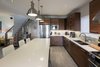The space is anchored with a custom designed kitchen and island. Photo 13 of Turkey Point Beach House modern home