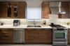 Book-matched and sequenced American Walnut wood was used in the kitchen. Photo 15 of Turkey Point Beach House modern home