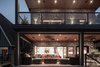 The deck and the floor levels are flush so that when the 16' glass wall is opened, the space flows seamlessly. Photo 4 of Turkey Point Beach House modern home