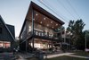 Beach Side: The Roof extension provides cover for the upper deck. The lower deck has a 16' retractable glass wall to connect to the living space. Photo of Turkey Point Beach House modern home