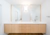 Modern home with Bath Room, Engineered Quartz Counter, Undermount Sink, and Light Hardwood Floor. Floating maple cabinetry at the master bath vanity provides for material continuity throughout the home's minimalist interior. Photo 13 of Villa Park Modern