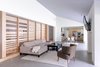Modern home with Living Room, Two-Sided Fireplace, Sofa, Ceiling Lighting, and Concrete Floor. A blue paint hue reflects the cool tones of the concrete floors and highlights the sloping ceiling at the open living room. Photo 11 of Villa Park Modern
