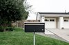 Modern home with Outdoor, Front Yard, Trees, Grass, Concrete Patio, Porch, Deck, Horizontal Fences, Wall, and Wood Fences, Wall. A modern mailbox at the traditional front exterior landscape hints at the design departure at the rear of the home. Photo 5 of Villa Park Modern