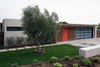 Modern home with Exterior, Wood Fences, Wall, Hardscapes, Walkways, Swing Door Type, Horizontal Fences, Wall, Attached Garage Room Type, Decomposed Granite Patio, Porch, Deck, Concrete Patio, Porch, Deck, Pavers Patio, Porch, Deck, Gardens, Shrubs, Outdoor, Front Yard, Grass, Flowers, and Large Patio, Porch, Deck. A focus on clean lines, carefully-selected materials, and a modernist aesthetic enhance the streetscape at this California mid-century modern courtyard home. Photo 8 of Laguna Niguel Mid-Century