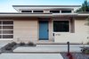 Modern home with Outdoor, Shrubs, Hardscapes, Walkways, Concrete Patio, Porch, Deck, Small Patio, Porch, Deck, and Post Lighting. blue door, staggered concrete and light-stained cedar at mid-century entry Photo 10 of Niguel West Mid-century Modern