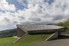 Modern home with Outdoor, Rooftop, and Slope. Organic Architecture exemplified here - an Ipe clad roof top rises gently from the grass. Photo of The Clifftop House