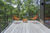 Modern home with Outdoor and Small Patio, Porch, Deck. Lake Home on Lake Lanier : The clients desired a home that could celebrate the lakeside site, for its views and trees. A home that could provide private spaces for owners and their guests, yet provide places for everyone to gather. Connection to the outside was of most importance, both visually thru the large windows and via the sliding glass doors. Photo of Lake House