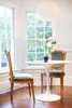 The kitchen sports a composition of ornate seating with a minimalistic Saarinen table. When renovating, antique heart pine was custom milled in 16' long boards and laid in a single run wall-to-wall, mimicking the home's original flooring. Photo 5 of SOMO: southern mod modern home