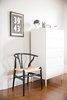 A high-low mix tempers the pedigree of Hans Wegner's Wishbone chair with the sensibility of an H front Ikea PS dresser; a letterpress printing of "The Line" by Old Try pays homage to the abode south of the Mason-Dixon. Photo 11 of SOMO: southern mod modern home