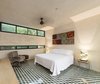 Modern home with Bedroom, Bed, Table Lighting, Cement Tile Floor, Chair, and Bench. Upstairs bedroom take advantage of the natural surounding from the neighborhood Photo 4 of Lemon Tree House