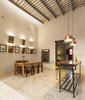 Modern home with Dining Room, Wall Lighting, Pendant Lighting, Chair, Table, Shelves, and Cement Tile Floor. The old ceilings and walls of the existing structure were preserved to keep the spirit of the old house Photo 6 of Lemon Tree House