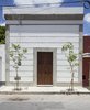 The simple facade from the street doesn't reveal the light , Airy and contemporary space behid the door! Photo 7 of Lemon Tree House modern home