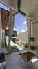 Modern home with Outdoor, Concrete Patio, Porch, Deck, Trees, Horizontal Fences, Wall, and Plunge Pools, Tubs, Shower. The two areas of the house get conected trough the stairs volume and the light cover for the passway Photo 5 of Lemon Tree House