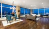 Modern home with Living Room, Chair, Sofa, Coffee Tables, Media Cabinet, End Tables, Lamps, Shelves, Table, Ceiling Lighting, Recessed Lighting, Accent Lighting, and Dark Hardwood Floor. Living Area Photo of Ritz-Carlton Residences, 48G