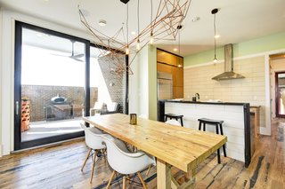 The kitchen island picks up on the same shou sugi ban, reclaimed wood as the top of the bar which waterfalls down the sides. 