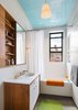 The ceiling is painted in a high gloss blue to energize the space. Photo 7 of A Chelsea Apartment modern home