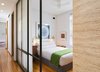 Walls at a narrow hall were replaced with wood and bronze framed glazed partitions. Photo 6 of A Chelsea Apartment modern home