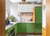 The kitchen cabinets in white, natural fir and two alternating shades of green inspired by Castelvetrano olives contrast with marble backsplashes. Photo 5 of A Chelsea Apartment modern home