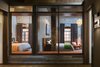 To bring light deep into the loft, the floor plan is open with glass partitions instead of solid walls at the north end of the loft. Photo 14 of Tribeca Loft modern home
