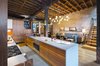 Beams and columns were restored back to their original condition revealing a rich charred color from a fire. The bent and twisted members create an ombre effect from floor to ceiling softening the large space. Photo 12 of Tribeca Loft modern home