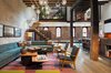 The residence is transformed by a relocated mezzanine featuring a sunken court which connects to the planted green roof garden above. Photo of Tribeca Loft modern home
