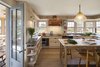 Modern home with Kitchen and Wood Cabinet. A semi-inverted plan takes advantage of the westen views and places the kitchen and dining room on the ground floor while the living room and main outdoor deck are on the second. Photo 6 of Meadow Beach House