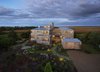 Modern home with Exterior, House Building Type, and Metal Roof Material. The house is oriented on the site to harness the near constant southwestern winds, with the two main volumes forming a breezeway that guides airflow into the structure. Photo of Meadow Beach House