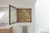 Modern home with Bath Room, Drop In Sink, and Freestanding Tub. Cedar slats help mitigate overly bright light and provide privacy. Photo 8 of Slatted Beach Retreat