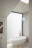 Modern home with Bath Room, Porcelain Tile Floor, Pendant Lighting, and Freestanding Tub. A previously muggy master bathroom was transformed into a light, open space. Photo 9 of Slatted Beach Retreat