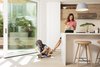 Modern home with Kitchen, Light Hardwood Floor, Wood Cabinet, and Pendant Lighting. Floor-to-ceiling sliding doors open the kitchen to one of the home's two patios. Photo 6 of Slatted Beach Retreat