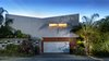 Modern home with Outdoor, Side Yard, Horizontal Fences, Wall, Landscape Lighting, Trees, Shrubs, and Flowers. Alley Elevation Photo of Land Park Residence