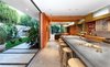 Modern home with Kitchen, Concrete Counter, Metal Cabinet, Wood Cabinet, Concrete Floor, Concrete Backsplashe, Accent Lighting, Recessed Lighting, Pendant Lighting, Refrigerator, Wall Oven, Cooktops, Range Hood, Dishwasher, and Undermount Sink. Inside / Outside living Photo 2 of Land Park Residence