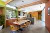 Modern home with Concrete Counter, Dining Room, Table, Bar, Stools, Accent Lighting, Chair, Storage, Pendant Lighting, Recessed Lighting, and Concrete Floor. Dining Room to Kitchen Photo 3 of Land Park Residence