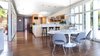 Modern home with Dining Room, Stools, Pendant Lighting, Table, and Medium Hardwood Floor. Dining to Kitchen. Wooden Louvers from inside. Photo 2 of Schindler Residence
