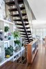 Modern home with Staircase, Glass Railing, Wood Tread, and Metal Tread. The stair up and down next to the 3 story book shelf Photo 3 of Schindler Residence