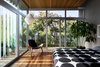 Modern home with Bedroom, Chair, Recessed Lighting, Medium Hardwood Floor, Bed, and Pendant Lighting. Guest room sliders open up 2 walls to the outside with glass louvers Photo 9 of Schindler Residence