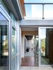Modern home with Hallway, Concrete Floor, Cement Tile Floor, and Medium Hardwood Floor. Private patio to inside hall to back yard. Flexible space. Photo 10 of Schindler Residence