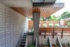 Modern home with Outdoor, Front Yard, Garden, Concrete Fences, Wall, Raised Planters, Shrubs, Slope, Gardens, Small Patio, Porch, Deck, Horizontal Fences, Wall, Walkways, Concrete Patio, Porch, Deck, Wood Patio, Porch, Deck, Stone Patio, Porch, Deck, Wood Fences, Wall, Retaining Fences, Wall, and Hardscapes. The light well that allows for sunlight AND an addition above Photo 11 of Schindler Residence