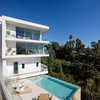 Modern home with Outdoor, Slope, Planters Patio, Porch, Deck, Shower Pools, Tubs, Shower, Hot Tub Pools, Tubs, Shower, Garden, Swimming Pools, Tubs, Shower, Side Yard, Shrubs, Large Patio, Porch, Deck, Landscape Lighting, Infinity Pools, Tubs, Shower, Flowers, Walkways, Wood Fences, Wall, Retaining Fences, Wall, Wood Patio, Porch, Deck, Trees, Horizontal Fences, Wall, and Gardens. Viewing Decks and Infinity Pool Photo 20 of Minimal House One