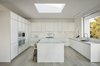 Modern home with Kitchen, Engineered Quartz Counter, Wall Oven, Stone Slab Backsplashe, Undermount Sink, Microwave, White Cabinet, Marble Counter, Range, Light Hardwood Floor, and Recessed Lighting. While minimally modern in the aesthetic, this home provides a comfortable space for the occupants to immerse themselves within nature.
Photo 5 of Minimal House One