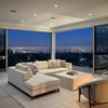 Modern home with Living Room, Chair, Accent Lighting, Ceiling Lighting, Ribbon Fireplace, Sofa, Gas Burning Fireplace, Light Hardwood Floor, Recessed Lighting, and Coffee Tables. Partial View of Los Angeles at Night Photo 9 of Minimal House One