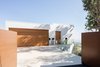 Modern home with Exterior, House, Flat RoofLine, and Stucco Siding Material. Gated Driveway Entry Photo of Minimal House One